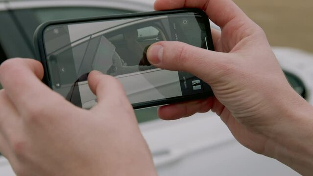 Discovering broken glass on car owner recorded for his phone to document damage. By capturing shattered window camera aims document incident ensuring perpetrators held accountable their actions.