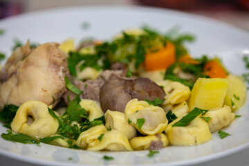 Traditional capeletti soup with chicken and vegetables. Typical winter dinner soup