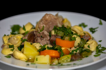 Traditional capeletti soup with chicken and vegetables. Typical winter dinner soup