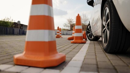 One of the traffic cones is knocked down during the practical driving test. Parking lesson in driving school