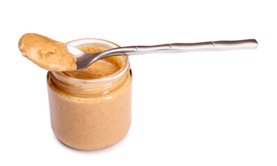 Tasty nut paste in jar and spoon isolated on white