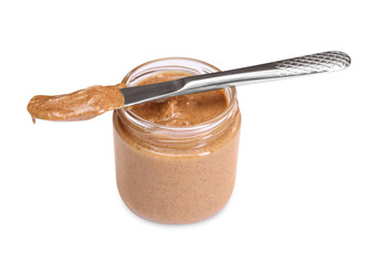 Tasty nut paste in jar and knife isolated on white