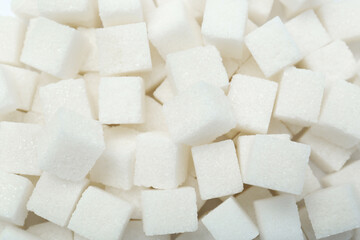White sugar cubes as background, top view