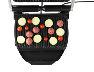 Electric grill with meat balls, zucchini and tomatoes isolated on white, top view