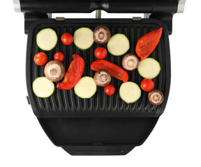 Electric grill with tomatoes, zucchini, bell pepper and mushrooms isolated on white, top view