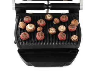 Electric grill with meat balls and mushrooms isolated on white
