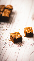 Chocolate chip brownies on a wooden background with crumbs around. Selective focus.