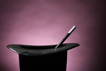 Magician's hat and wand on dark background