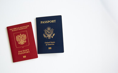 Close up of an American and Russian passports on white table background