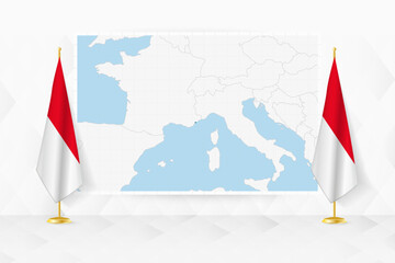 Map of Monaco and flags of Monaco on flag stand.