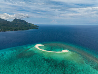 Beautiful sandbar formation with turquoise sea water and waves in White Island. Camiguin, Philippines.