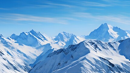 Panoramic view of the snow-capped mountains under a blue sky