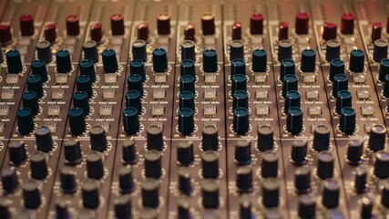 Music recording studio control room with pre amp knobs used for volume level adjustments. Stereo...