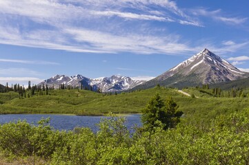 Fototapeta premium Lake among mountain peaks along the Canol road, Yukon.