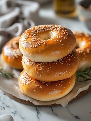 Close-up of a delicious stack of sesame bagels on a parchment paper, with kitchen backdrop implying homemade freshness and breakfast appeal