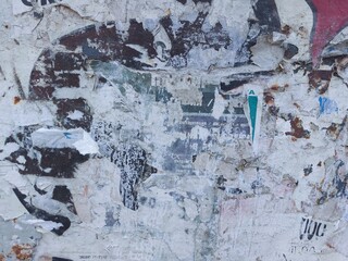 Fototapeta premium Torn and ripped street poster background, abstract and messy old paper art collage