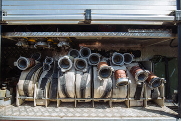 Rolled fire hoses in firetruck