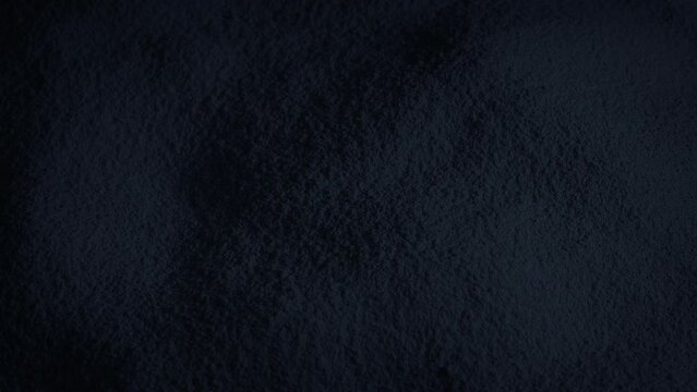 Black Powder Material Rotating Slowly
