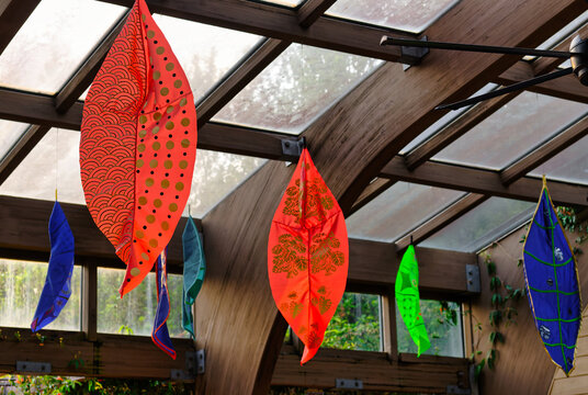 A view of colorful leaf lanterns or mobiles hanging at the entrance to the JC Raulston Arboretum in Raleigh, North Carolina.