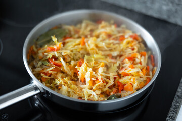 Delicious spanish dish with cabbage and pepper for lunch in frying pan