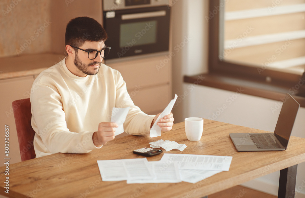Poster Man Sitting at Table With Laptop and Papers