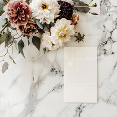 A white card with a flower on it sits on a marble counter. The card is for a wedding and has a floral design