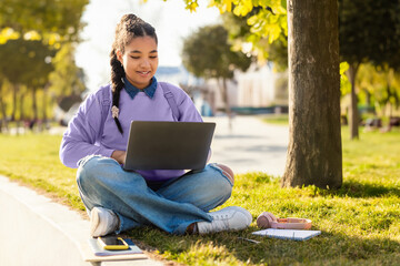Girl Sitting on Ground Using Laptop, Studying Online at Park