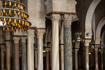 Forest of marble ornate Corinthian columns with inverted bell shaped capitals stylized as acanthus...