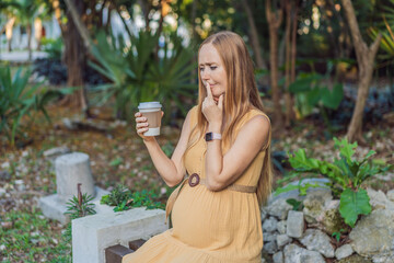 A pregnant woman doubts whether she should drink coffee during pregnancy