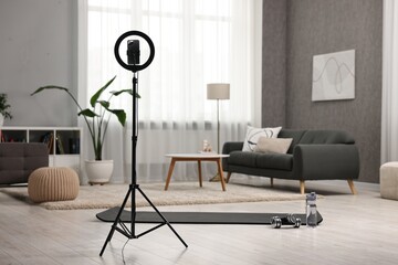 Ring light with smartphone and sports equipment at home