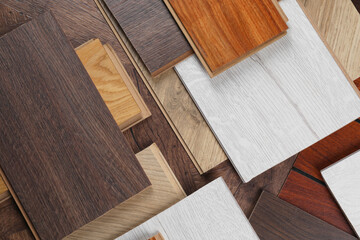 Fototapeta premium Different samples of wooden flooring as background, flat lay