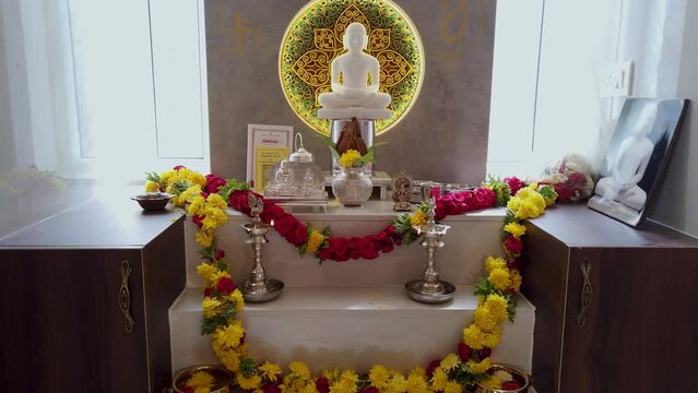 Mysuru, Karnataka, India-February 17 2024; A Divine view of a Puja or worship room with the God Lord Mahavira sculpted in white marble stone at a devotee of Jainism in India.