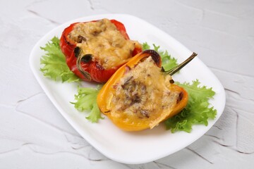 Delicious stuffed peppers on white textured table