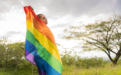 Libertad, igualdad y lgbtq con una mujer hispano latina feliz afuera celebrando su igualdad o inclusión gay 
