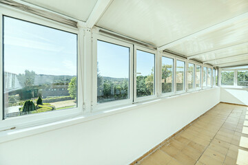A closed terrace with large aluminum and glass windows with good mountain views
