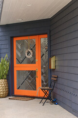 bright orange dutch door with beveled glass details