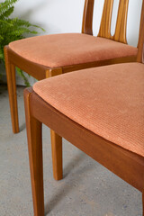 Vintage 1980s teak dining chairs. Mid-century modern style furniture with peach upoholstry. ...