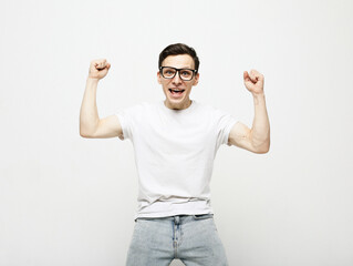 Naklejka premium young man celebrating victory over white background