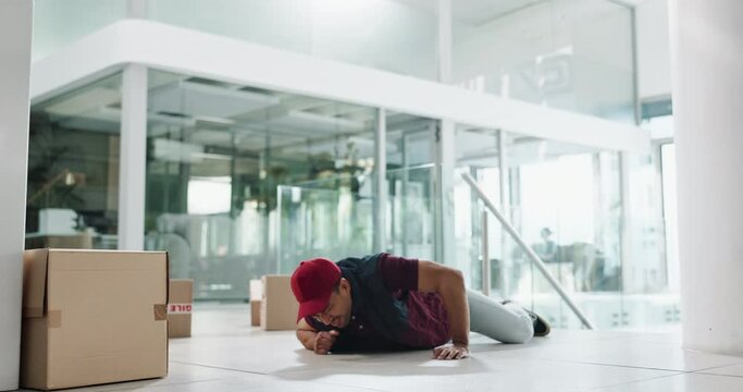 Delivery man, boxes and falling with package for accident, misstep and injury or mistake in a building or office. Courier worker or person with fragile stock for distribution risk, safety or balance