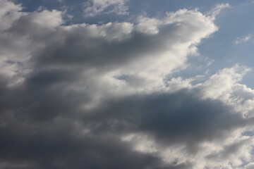 cloudy sky with rare dark gray clouds with threat of rain