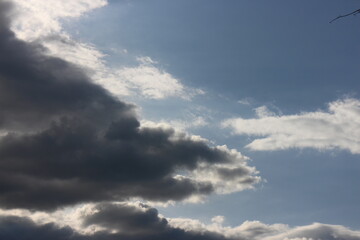 cloudy sky with rare dark gray clouds with threat of rain