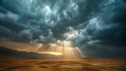 Dramatic cloudscape over vast desert terrain - A captivating cloudscape with sun rays bursting through dark storm clouds, illuminating a sprawling desert below
