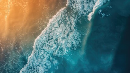 Aerial view of sunlit ocean shore with foam crashing waves