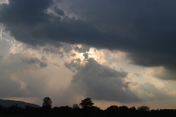 Sky blue and orange light of the sun through the clouds in the sky