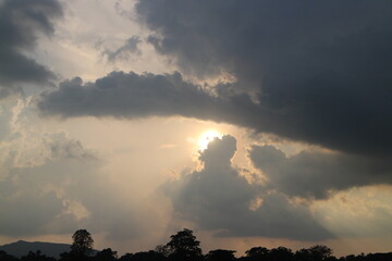 Obraz premium Sky blue and orange light of the sun through the clouds in the sky