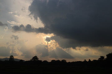 Sky blue and orange light of the sun through the clouds in the sky