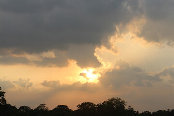 Sunset sky clouds in the Evening with Golden orange sunlight in golden hour, Dusk sky background.