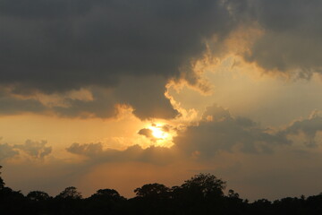 Sunset sky clouds in the Evening with Golden orange sunlight in golden hour, Dusk sky background.
