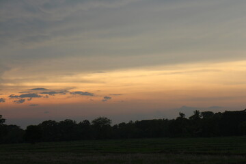 Real amazing panoramic sunrise or sunset sky with gentle colorful clouds.