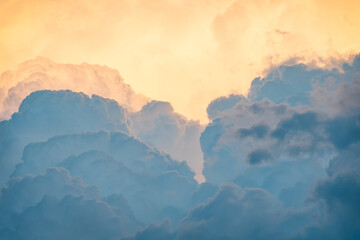 Close-up shot of clouds with different shades of gray and orange reflecting sunlight at sunset....